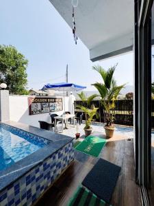 a house with a swimming pool and a patio at Lonavala Golden Bird 3 bhk villa in Malavli