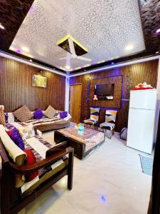 a living room with a couch and a table at Lonavala Golden Bird 3 bhk villa in Malavli