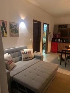 a living room with a couch and a table at Chalé I - Village da Serra in Serra de São Bento