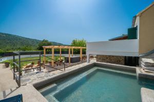 a swimming pool in the backyard of a house at Holiday house with heated pool in Neorić