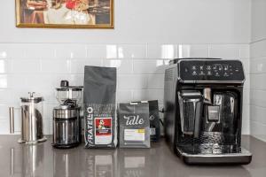 a counter top with a coffee maker and a coffeemaker at Arcade King Bed Espresso Maker Family Friendly in Airdrie