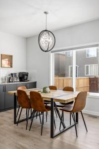 a kitchen and dining room with a table and chairs at Arcade King Bed Espresso Maker Family Friendly in Airdrie
