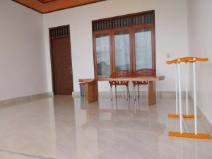a room with a table and two chairs and windows at Toba Sunset in Tuktuk Siadong +45 photos