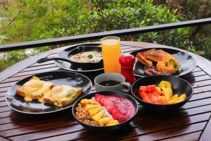 a tray of food on a table with plates of food at Domus Glamping Guatapé in Guatapé