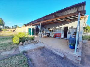 a house with a large patio with aestead at Die Pophuis in Aberdeen +18 photos