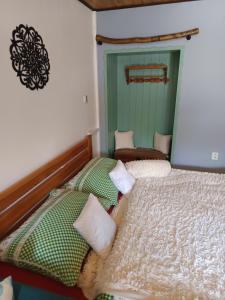 a bedroom with two beds and a green door at TUTTO Home in Frýdlant nad Ostravicí +38 photos