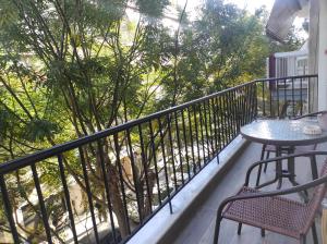 a balcony with a table and chairs and a tree at Twins in Serres