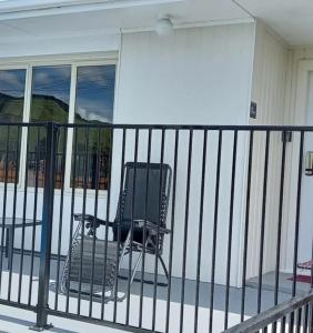 a chair sitting on the front porch of a house at B&B on Station in Paeroa