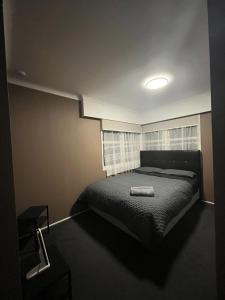 a bedroom with a bed and a window at B&B on Station in Paeroa +2 photos