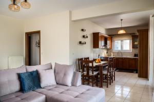 a living room with a couch and a kitchen at Ioana Sea View in Corfu
