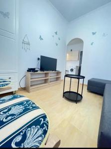 a room with a bed and a tv in it at Roy Apartments in Durrës