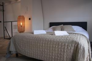 a bedroom with a large bed with two pillows at Loft 15 in Alkmaar