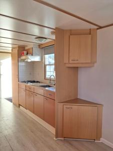a kitchen with wooden cabinets and a sink at 17e straatje in Elburg +30 photos
