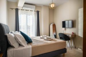 a bedroom with a bed with a window and a desk at Ioana Sea View in Corfu