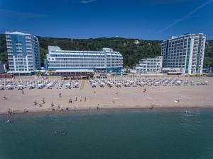 a group of people on a beach with buildings at Berlin Golden Beach Studio in Varna City