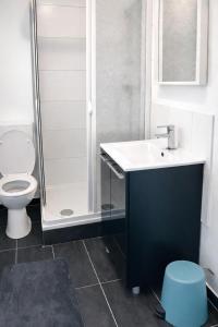 a bathroom with a toilet and a sink and a shower at Apartments in Leuna in Leuna