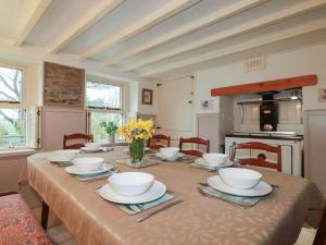 a dining room table with bowls and plates on it at Plenteth in Truro