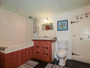 a bathroom with a toilet and a tub and a sink at Plenteth in Truro +23 photos