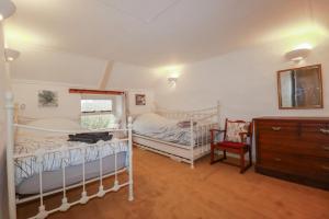 a bedroom with two bunk beds and a dresser at Plenteth in Truro