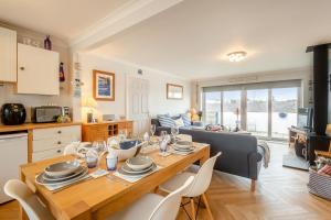 a kitchen and living room with a wooden table and chairs at 3 Bed in Abersoch oc-c33667 in Abersoch