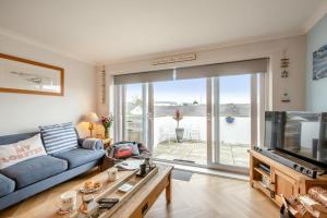a living room with a blue couch and a tv at 3 Bed in Abersoch oc-c33667 in Abersoch