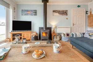 a living room with a couch and a fireplace at 3 Bed in Abersoch oc-c33667 in Abersoch