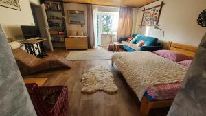 a living room with a bed and a couch at TUTTO Home in Frýdlant nad Ostravicí