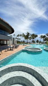 a swimming pool with blue water in a resort at Casa Marimar Milagres- Praia do Marceneiro in Passo de Camarajibe