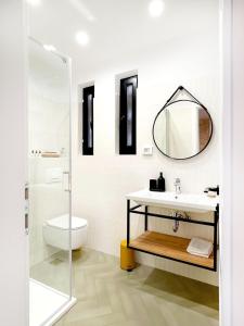 a bathroom with a sink and a toilet and a mirror at Golden View - Old town apartment in Rovinj +32 photos