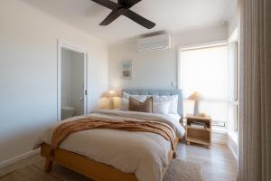 a bedroom with a bed and a ceiling fan at The Nook in Aldinga Beach