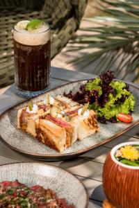 a table with two plates of food and a drink at Radisson Rio de Janeiro Barra in Rio de Janeiro