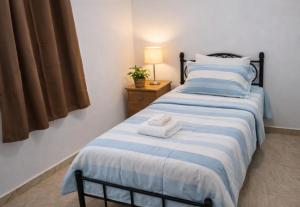 a bedroom with a bed with two towels on it at D'eaU BleU Villa-Private pool in Pereybere