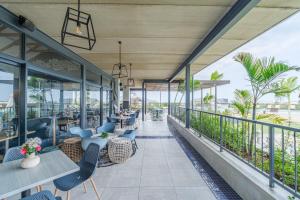 a restaurant with blue chairs and tables on a balcony at Ballito Hills 830 in Ballito