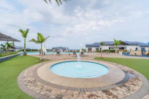 a swimming pool with a fountain in a park at Ballito Hills 830 in Ballito
