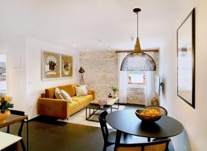 a living room with a yellow couch and a table at Golden View - Old town apartment in Rovinj