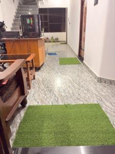 an office with green carpeted floors and a desk at Shree Rameshth Homestay in Ayodhya