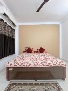 a bedroom with a large bed with red pillows at Shree Rameshth Homestay in Ayodhya