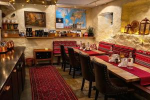 a restaurant with tables and chairs in a room at Hotel Tre Små Rum in Stockholm
