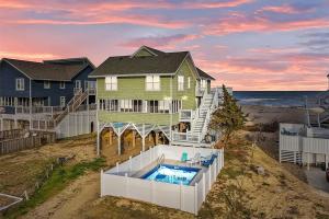 an aerial view of a house with a swimming pool at Beachfront Villa Royale OBX in Avon