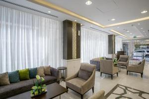 a lobby with couches and chairs in a building at Taba Al Salam in Medina