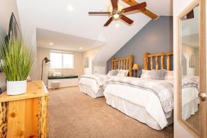 a bedroom with two beds and a ceiling fan at Powder Mtn Retreat MH110 Near Powder Mtn Hot Tub in Eden
