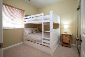 a white bunk bed in a room with a desk at Ski Paradise MH 303 Near Powder Mtn Hot Tub in Eden