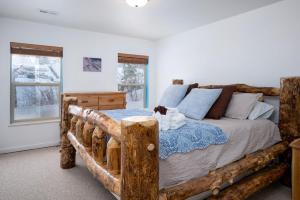 a bedroom with a bed made out of logs at Ski Paradise MH 303 Near Powder Mtn Hot Tub in Eden