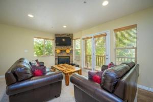 a living room with two leather couches and a table at Ski Paradise MH 303 Near Powder Mtn Hot Tub in Eden