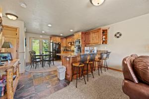 a kitchen and living room with a bar and chairs at Eden Mtn Retreat MH207 Near Powder Mtn Hot Tub in Eden
