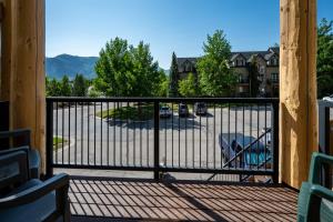 a balcony with a gate and a parking lot at Eden Mtn Retreat MH207 Near Powder Mtn Hot Tub in Eden +102 photos