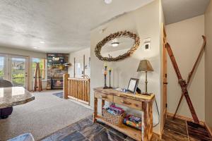 a living room with a table and a mirror at Eden Mtn Retreat MH207 Near Powder Mtn Hot Tub in Eden