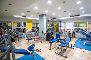 a gym with a lot of treadmills and machines at Elia House In Kapparis in Paralimni