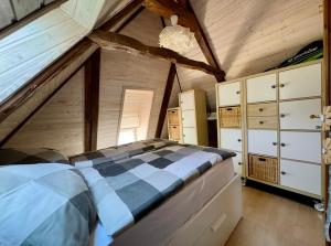 a bedroom with a large bed in a attic at Emmis-Ferienhaus in Dörpling