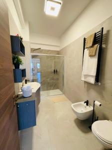 a bathroom with a toilet and a sink and a shower at Bencivenga Terrace in Rome +20 photos